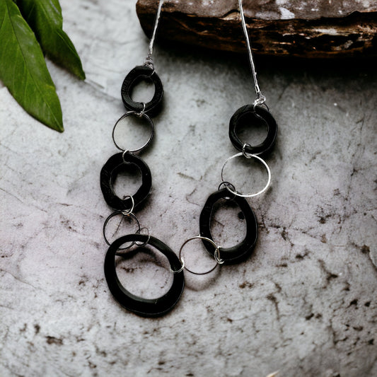 Black irregular shapes with silver accents chain
