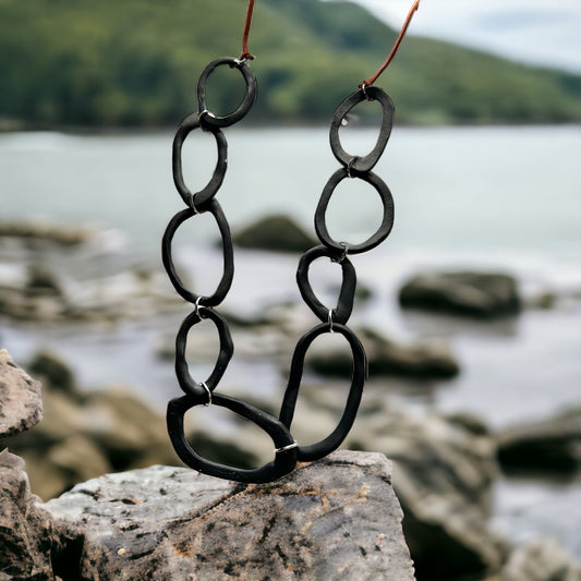 Black irregular shapes with brown cording